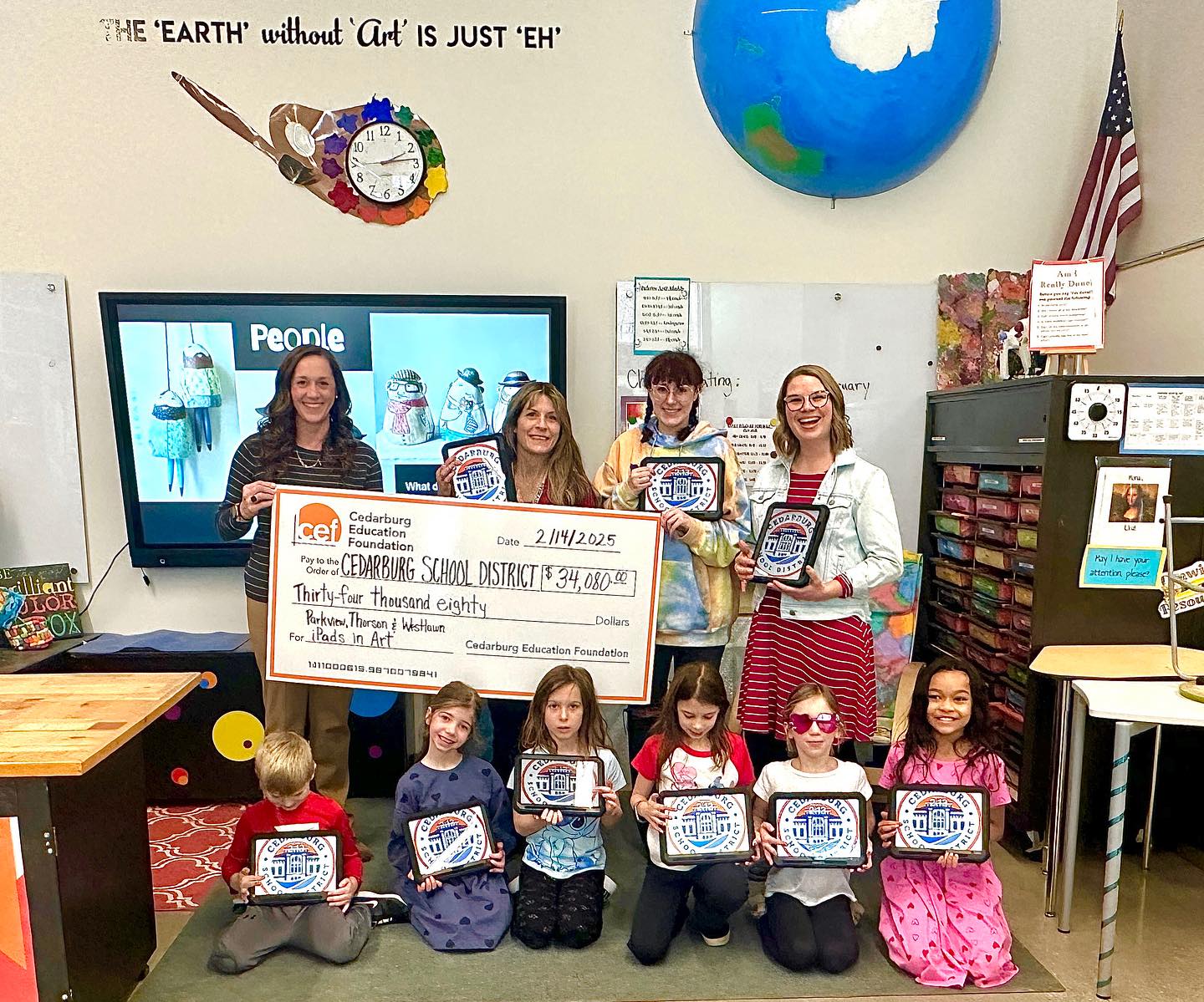 Class being presented giant check